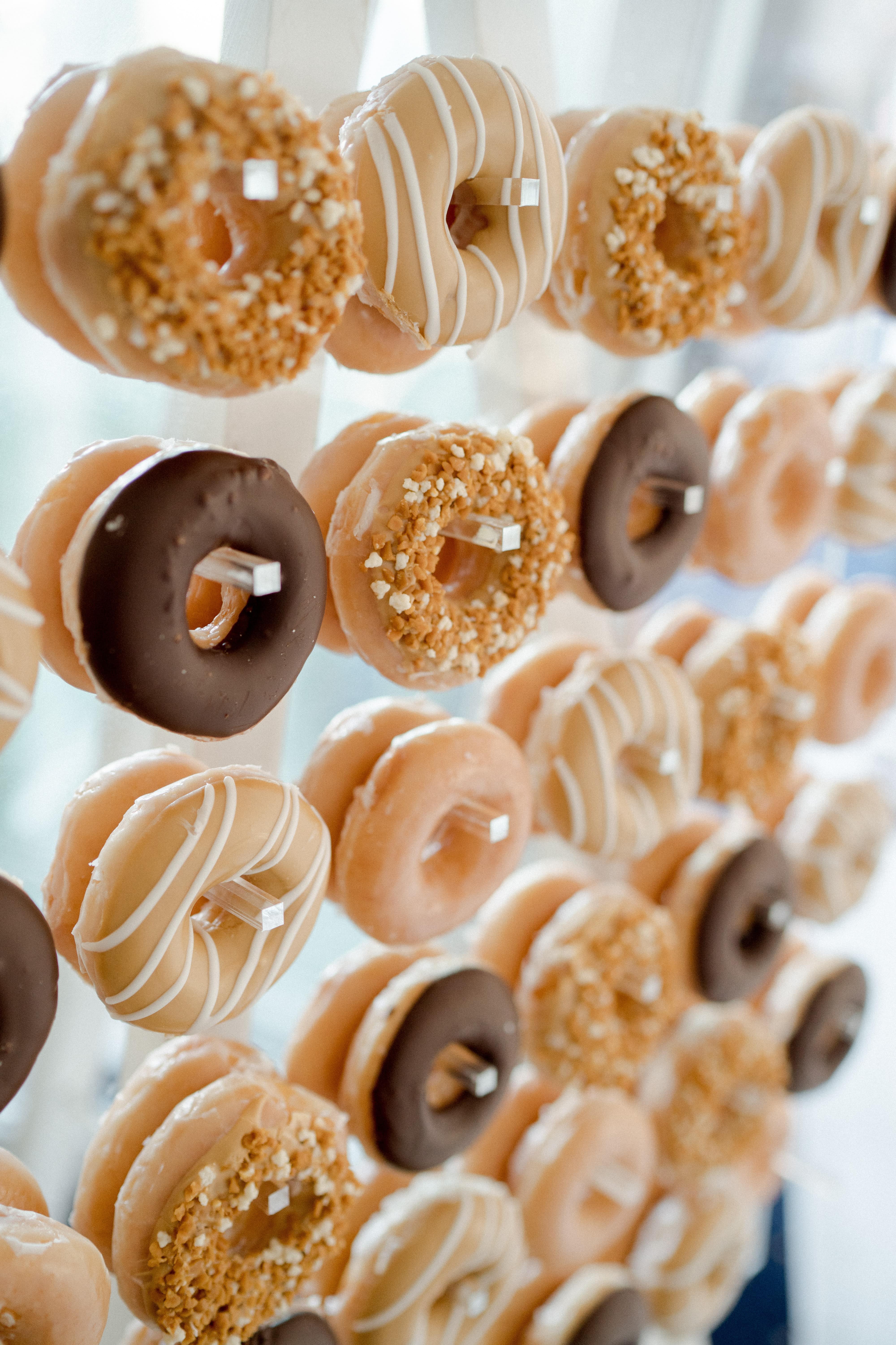 Decadent Donut Wall for your guests to dive into for dessert, or to accompany delicious wedding cakes in Sydney.