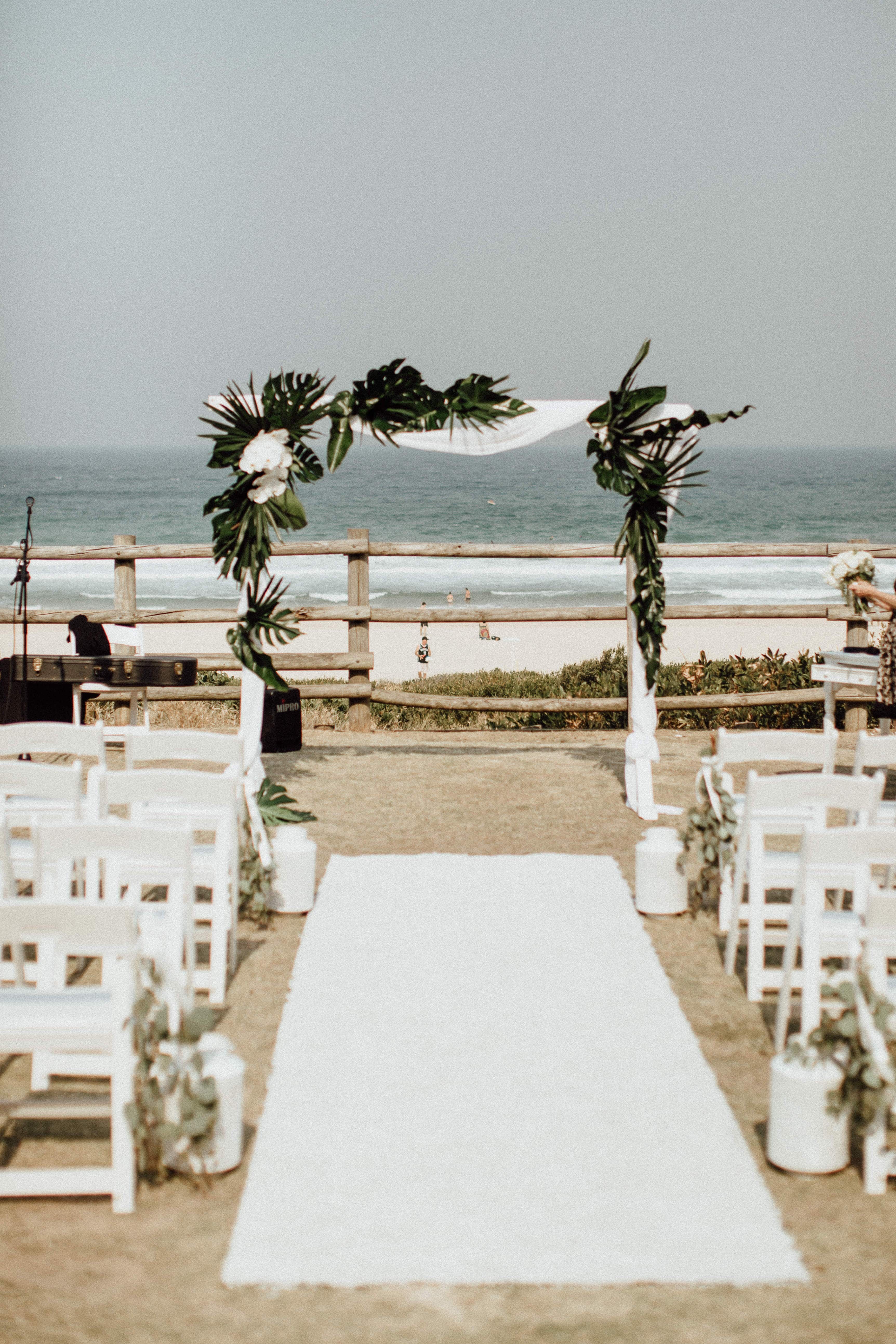 Tropical Flowers and Greenery for Wedding Arbour at Beach Ceremony Venue Sydney.